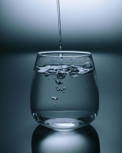 Clear water being poured into a drinking glass